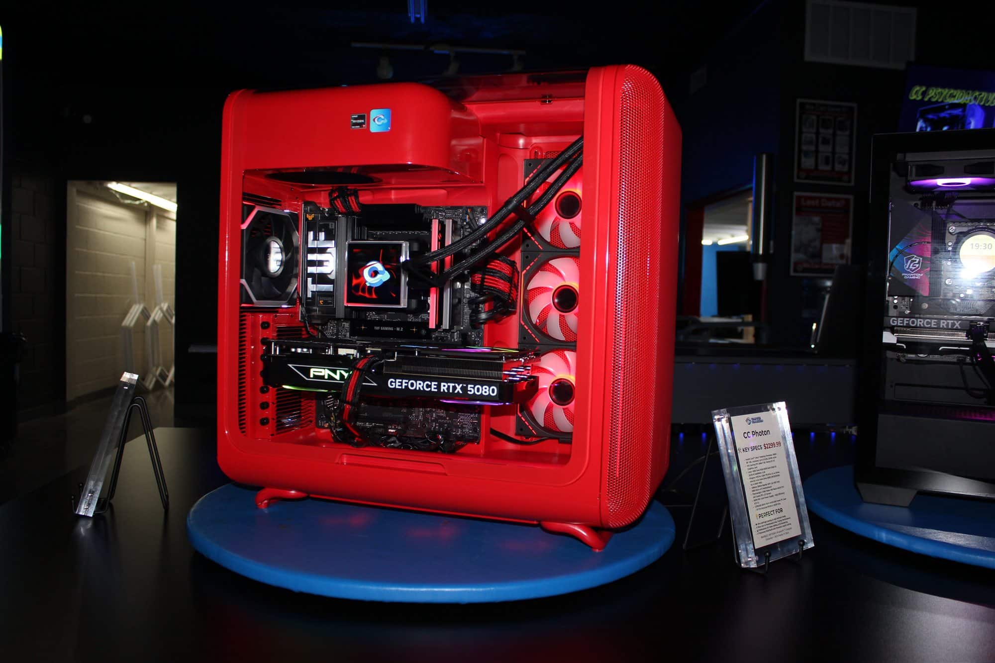 CC Alpha custom PC in a red HYTE case on the showroom turntable